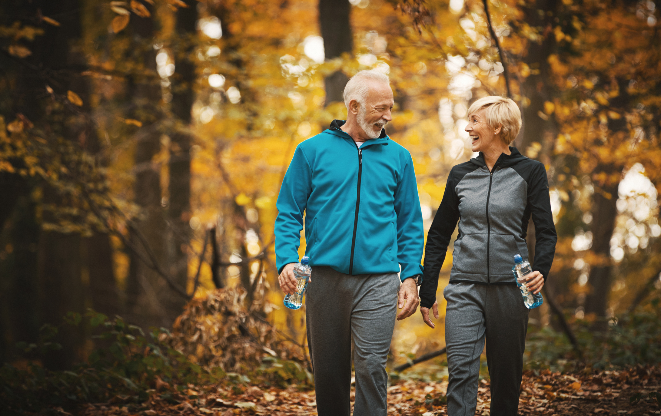 Senior couple walking as a healthy living tip during the fall season.