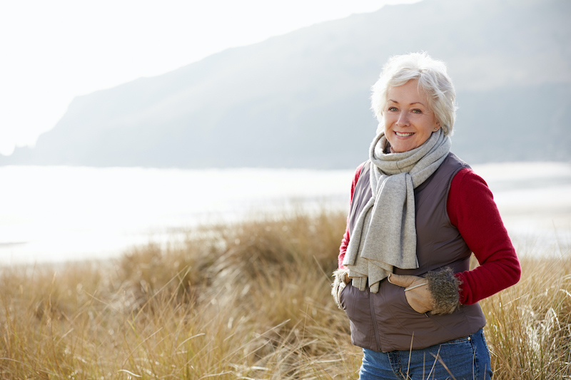 A senior woman focuses on winter health by getting outside on a nice winter day.